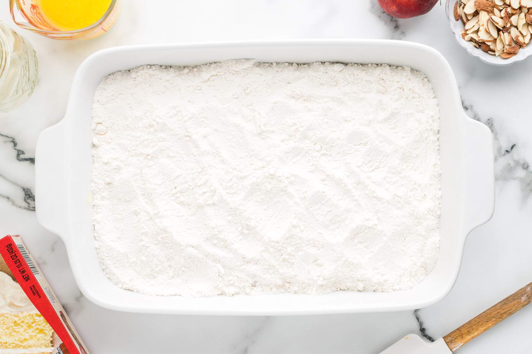 cake mix being added on top of pie filling