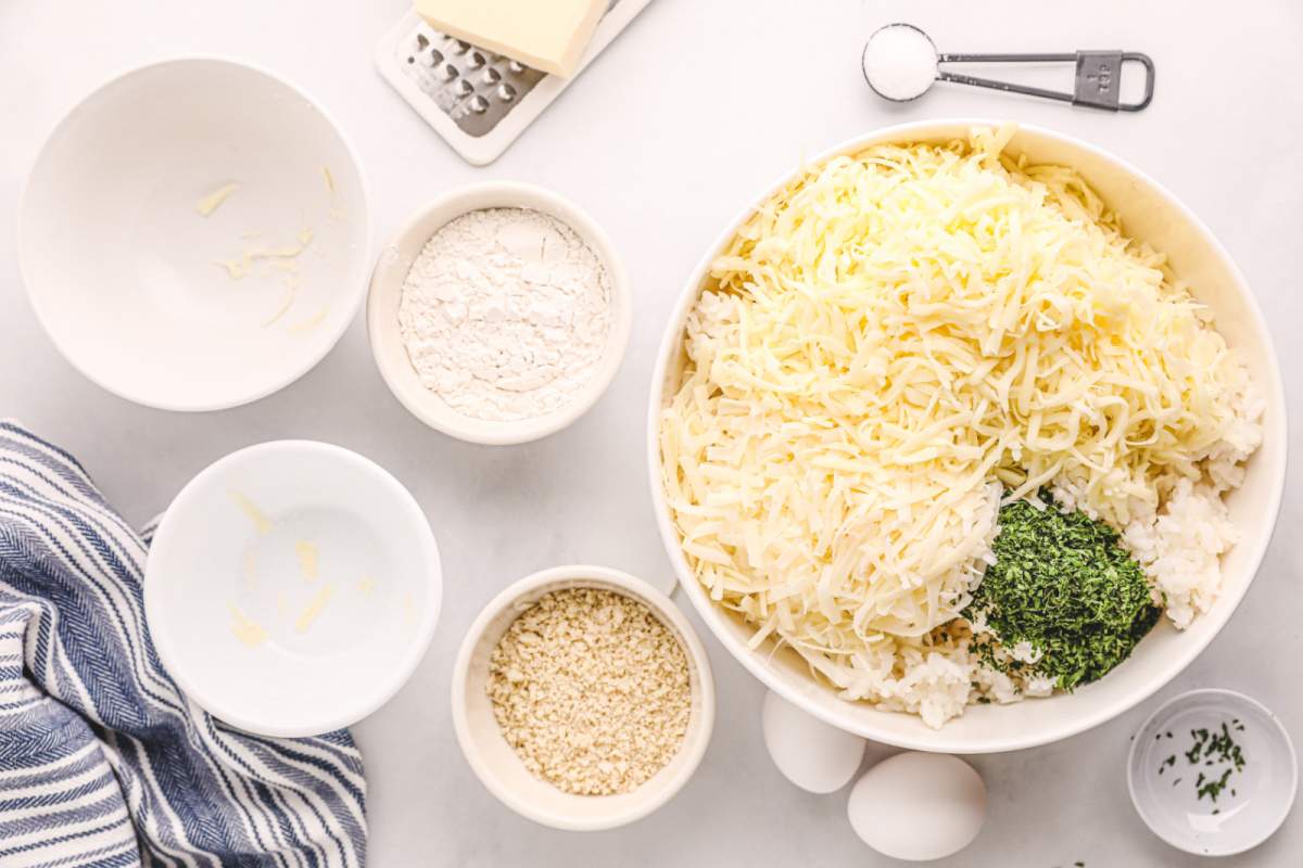 adding mozzarella cheese, parmesan cheese, parsley, and salt to the cooked rice