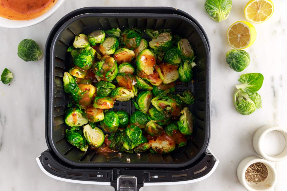 adding sauce to sprouts in air fryer