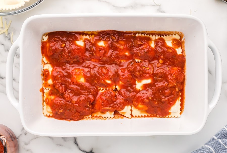 ravioli and sauce in a baking dish