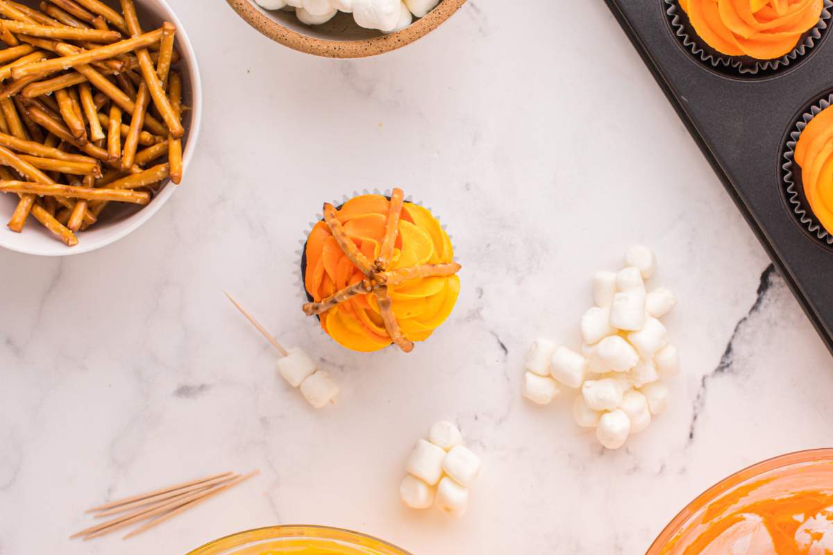 pretzel sticks added to top of cupcake