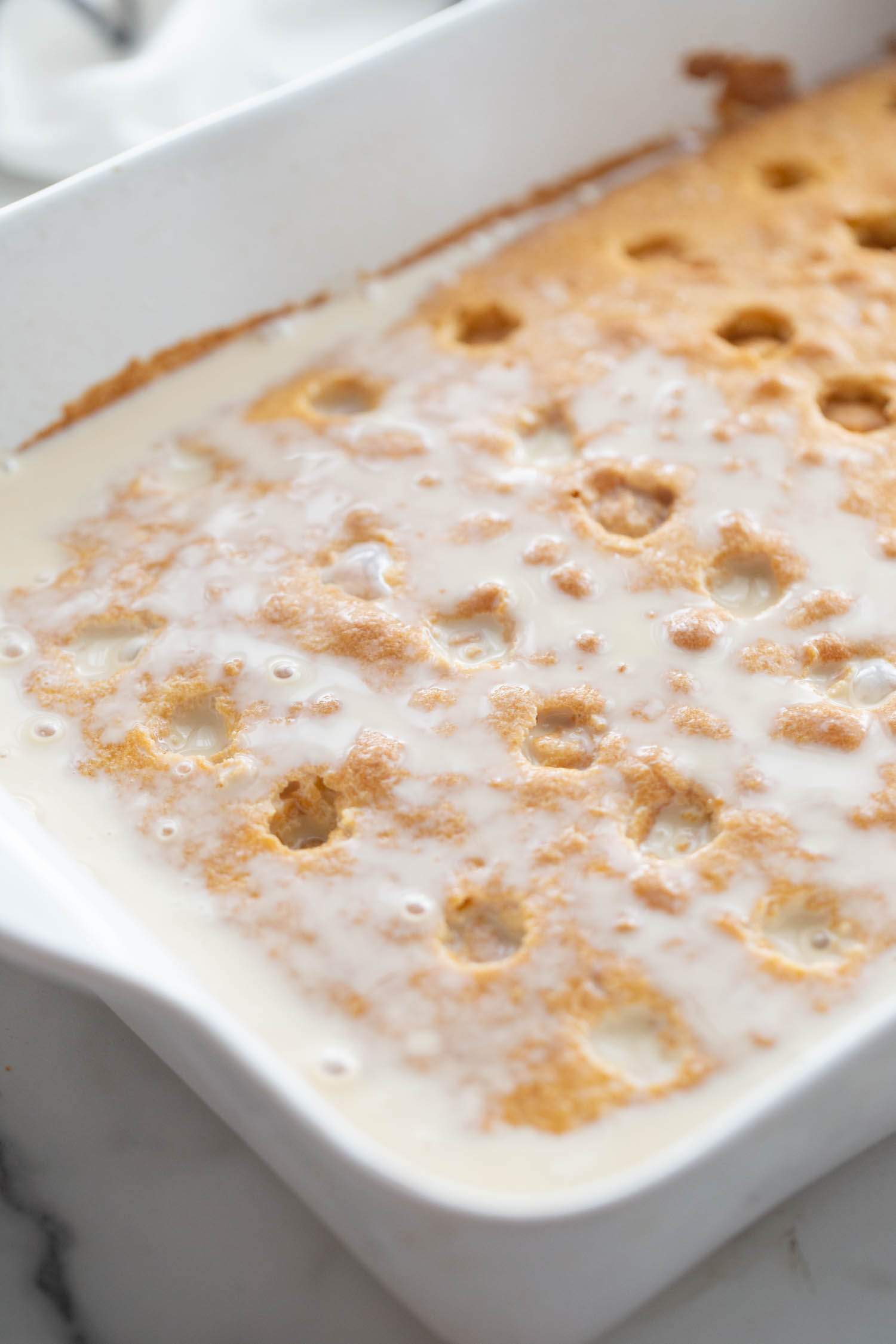 milk mixture poured over cake