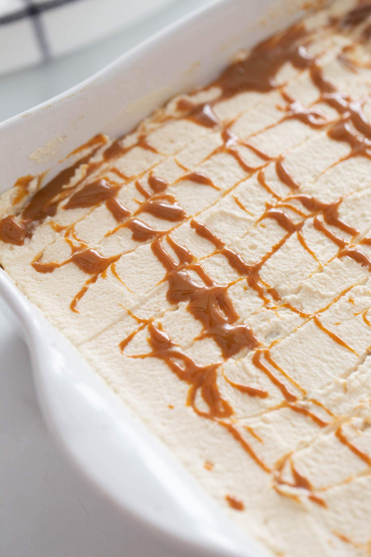 whipped topping and caramel added to top of cake