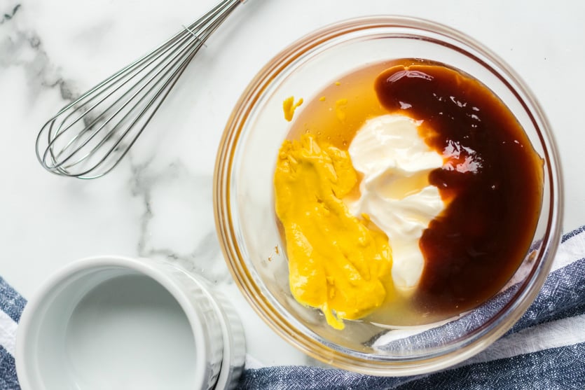 Copycat Chick Fil A Sauce - honey, mustard, bbq sauce and mayo in a mixing bowl - Family Fresh Meals