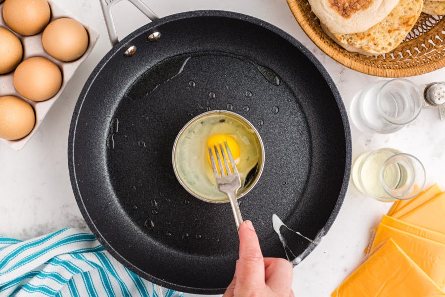 fork breaking up yolk of egg