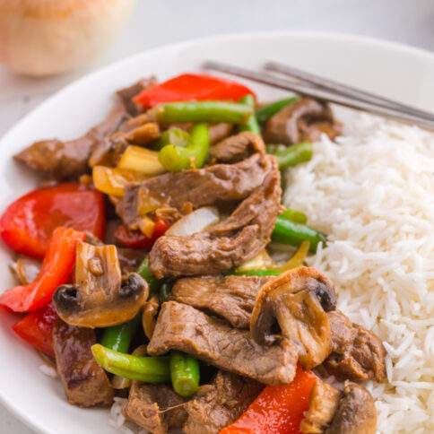 Copycat Panda Express Black Pepper Beef on a plate with rice