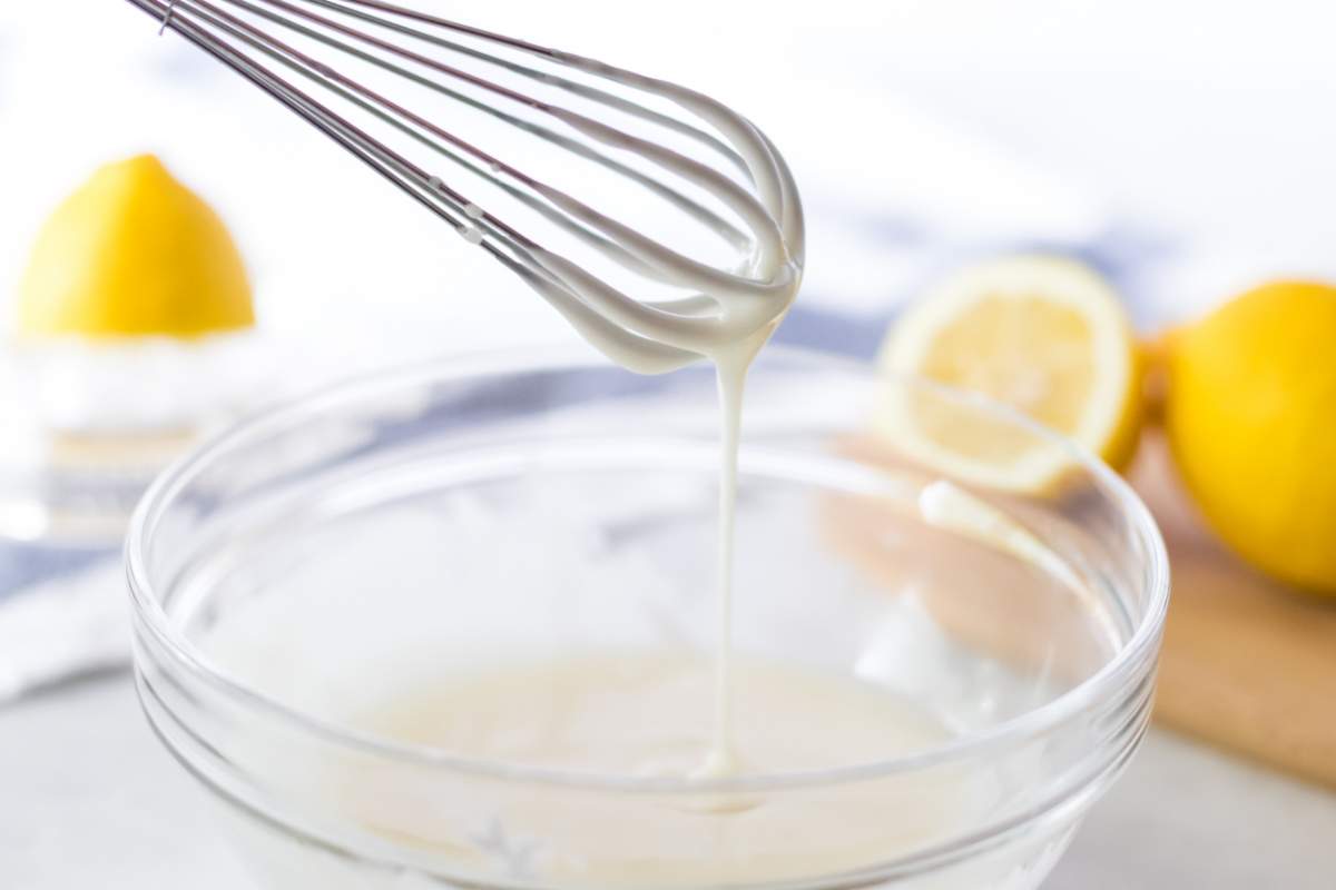 whisking icing mixture in bowl