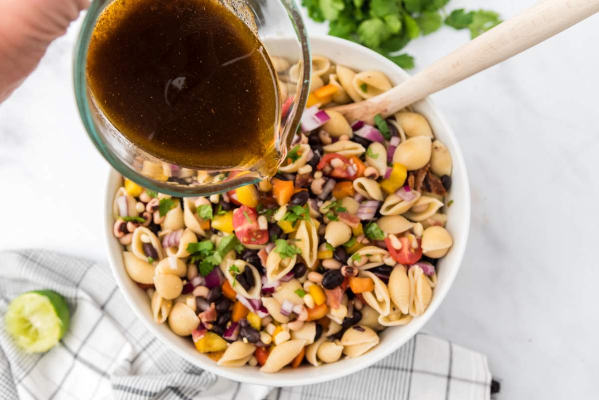 pouring dressing over salad