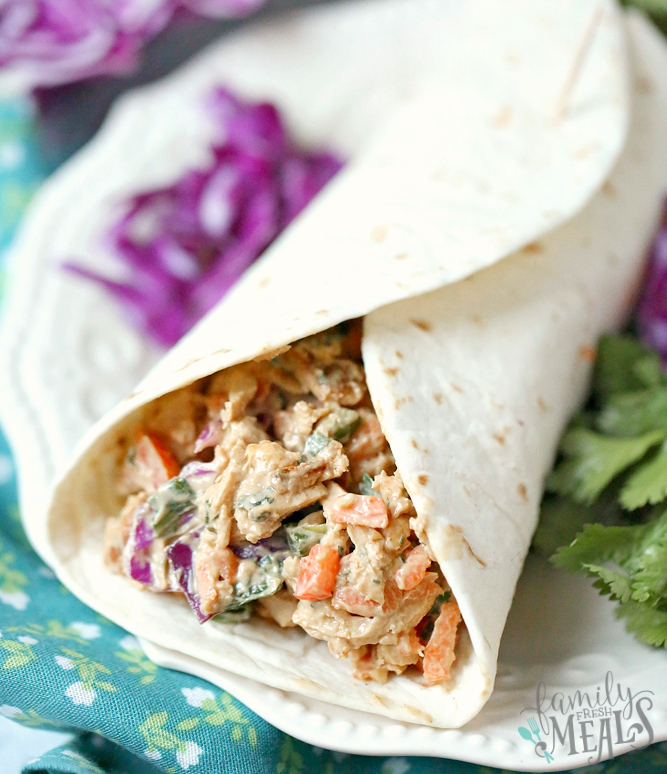 Creamy Thai Chicken Salad - Chicken salad served in a flour tortilla on a white plate