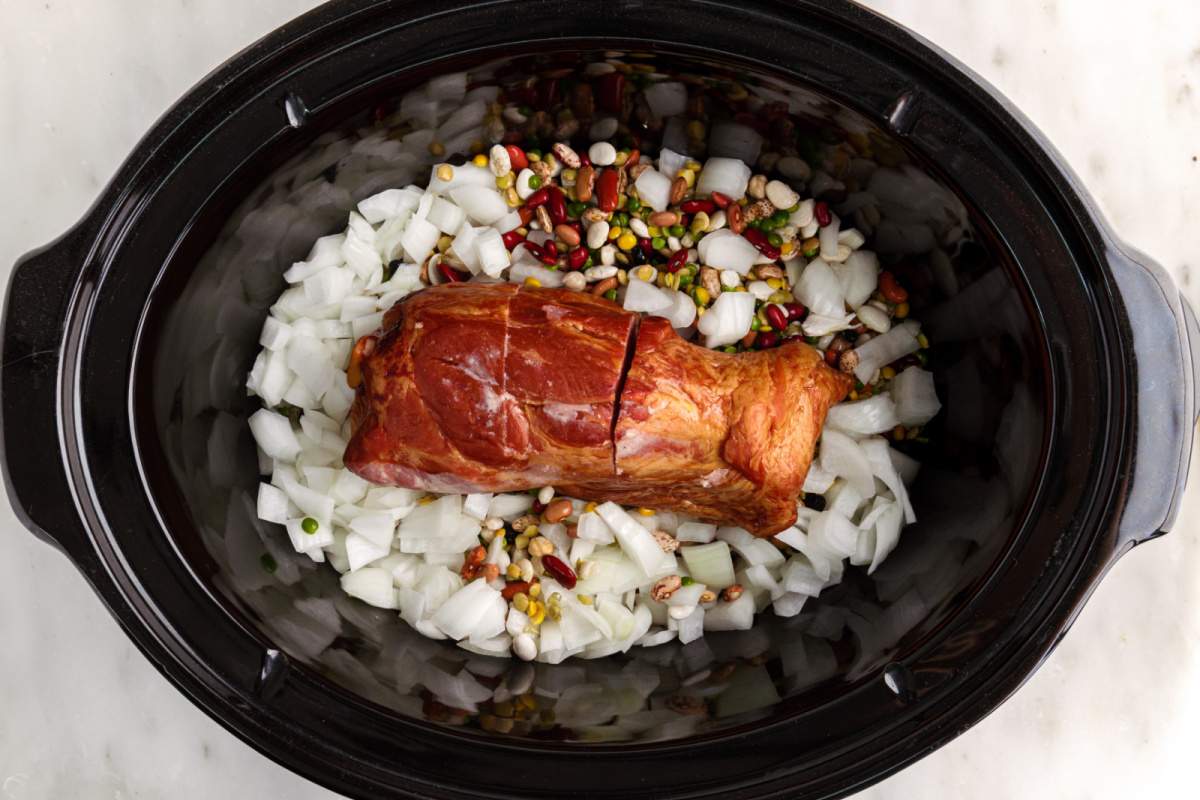 beans, onions and ham hock added to slow cooker