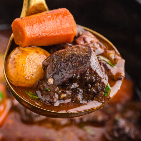 Ladle scooping up some Crockpot Beef Bourguignon