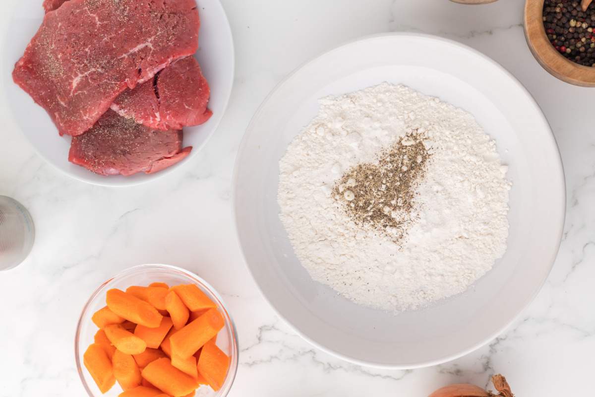 flour with the salt, pepper, and garlic powder on a plate