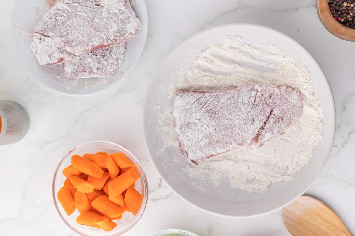 dredging steaks in flour mixture