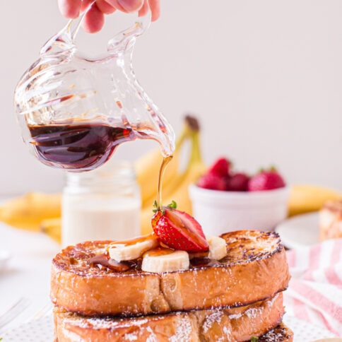 syrup being poured over Eggnog French Toast