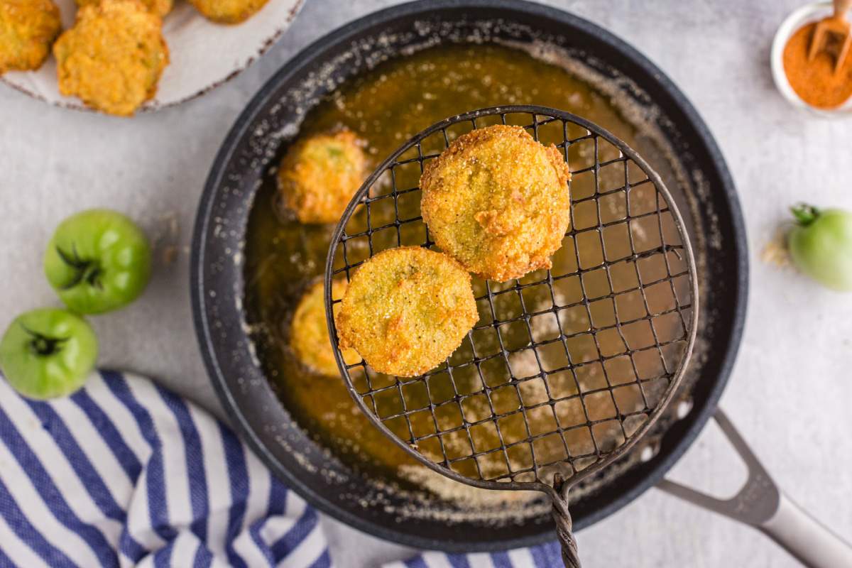 removing fried tomatoes from oil