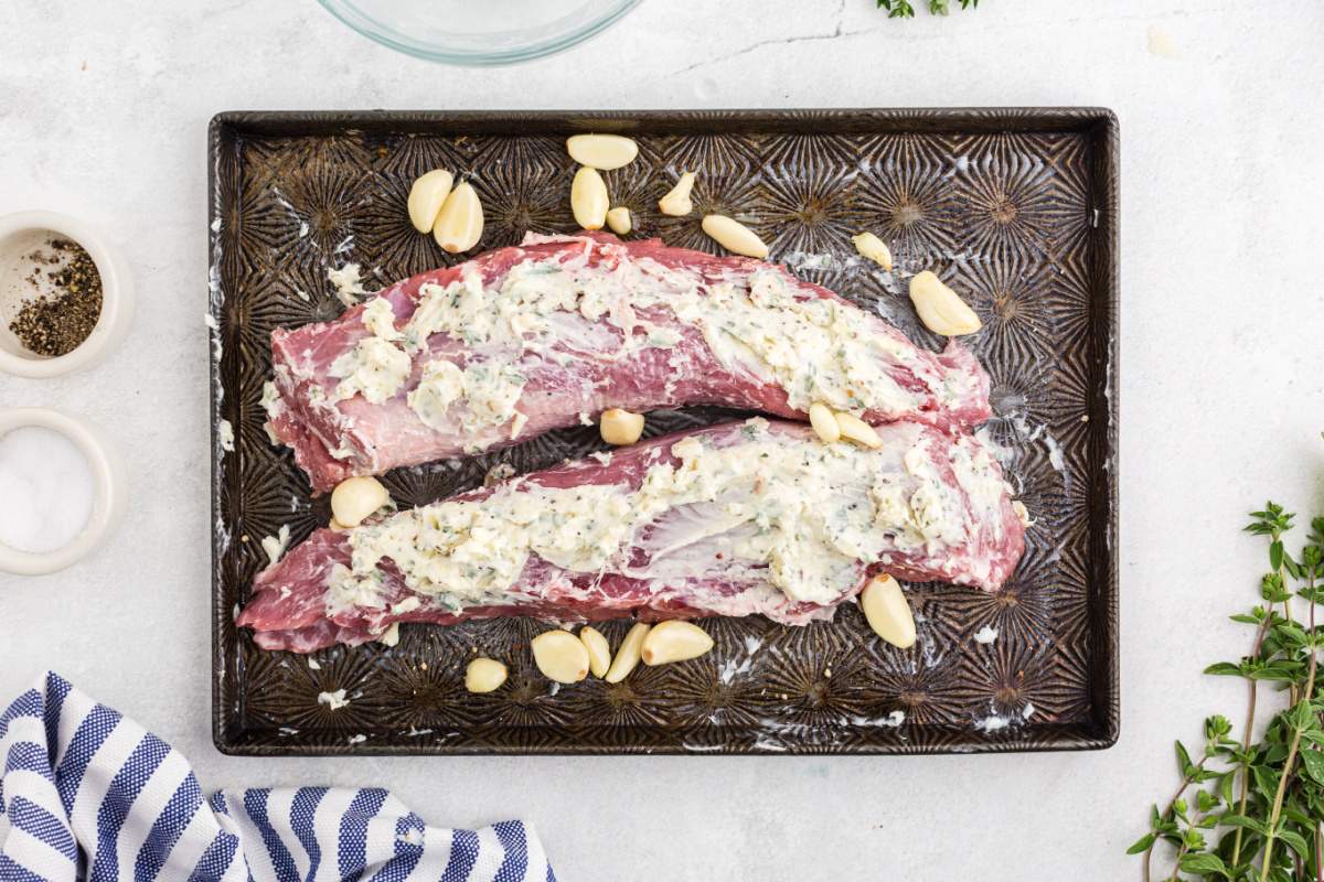 pork tenderloin with butter mix and garlic on pan