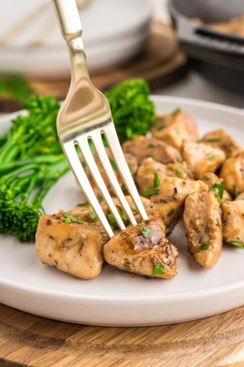 Garlic butter chicken bites on a plate with broccoli