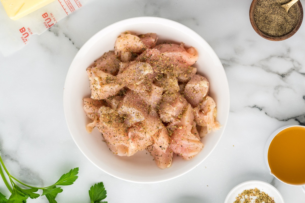 chicken bits in a bowl with seasoning