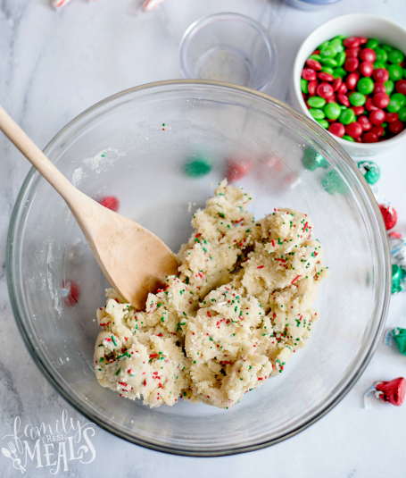 Holiday Sugar Cookie Cake - Adding holiday sprinkles to cookie dough