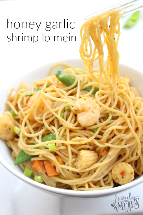 Honey Garlic Shrimp Lo Mein in a white bowl with chop sticks