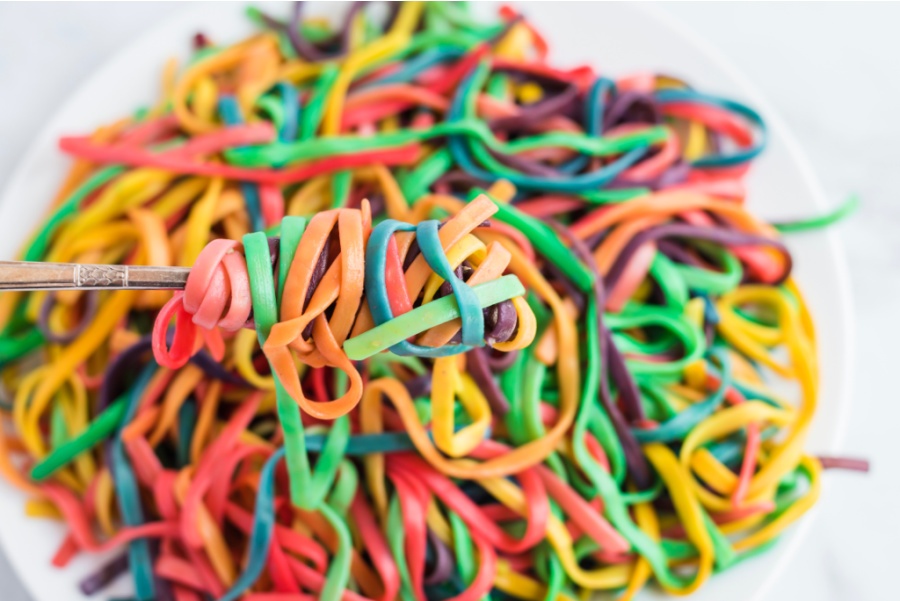 a fork holding some rainbow pasta