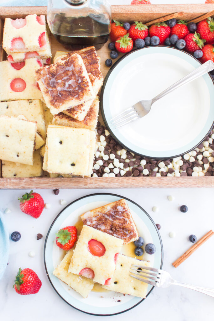 sheet pan pancakes cut up on plater and plate