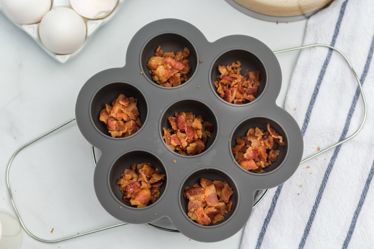 Instant Pot Bacon Cheddar Egg Bites - crumbled bacon in egg bite mold