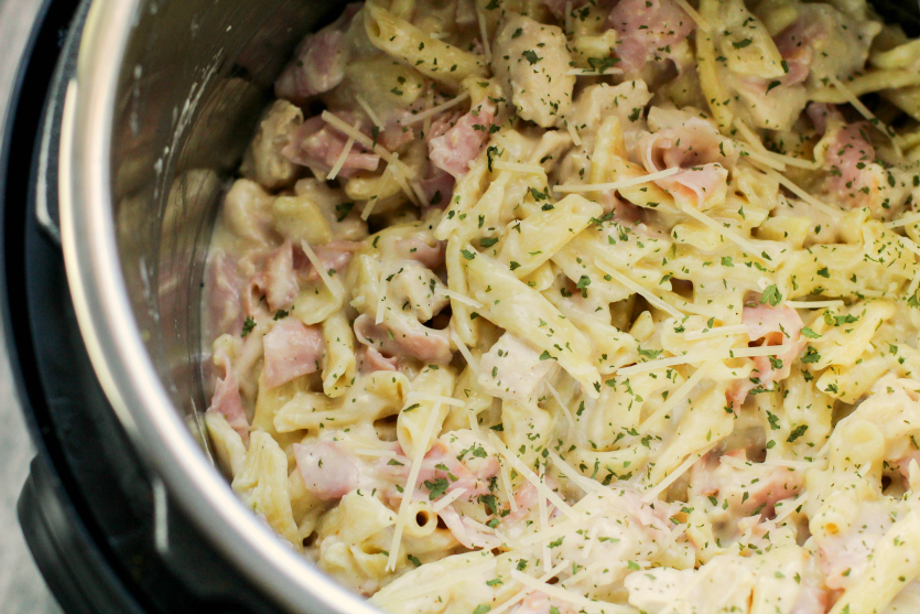 Instant Pot Chicken Corden Bleu Pasta - cooked pasta in instant pot, topped with cheese and parsley