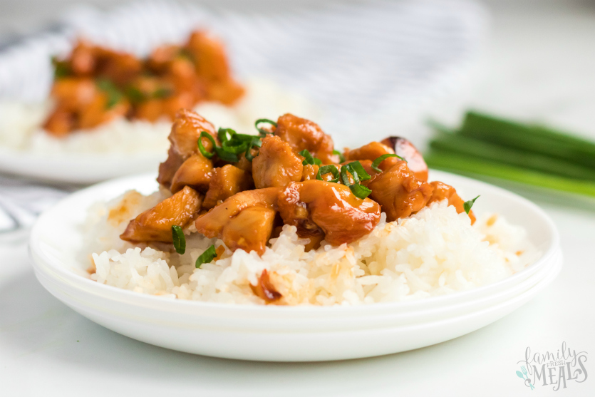 Instant Pot Orange Chicken - Two plates of orange chicken served over rice on a white plate