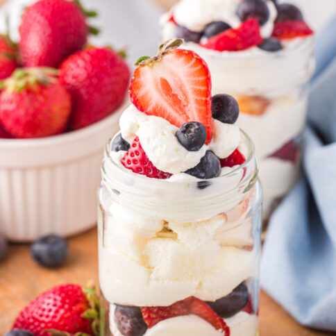 3 mason jar July 4th Angel Food Cake Trifle with a bowl of berries