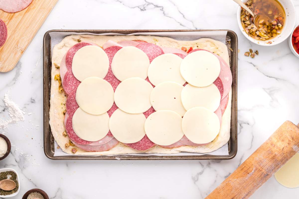 sliced cheese added to top of meats