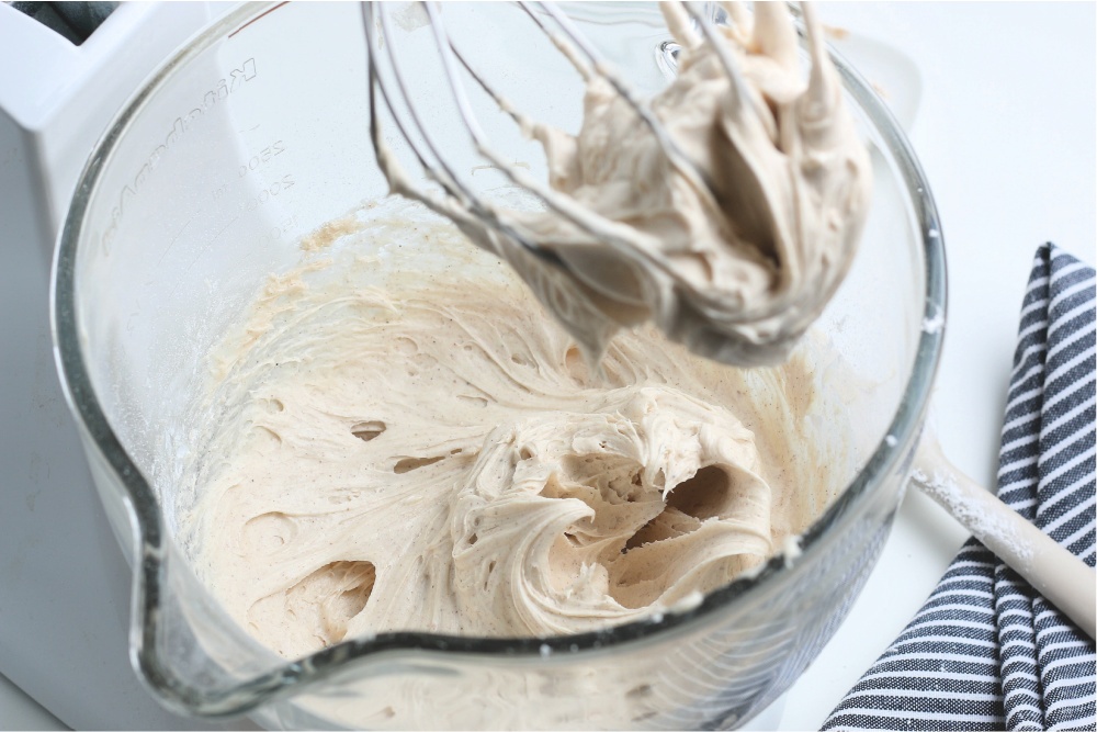 Frosting being mixed in a mixing bowl