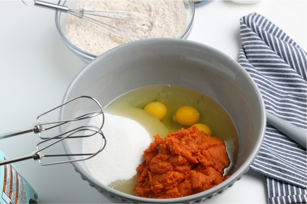 mixing ingredients for pumpkin bars in a bowl