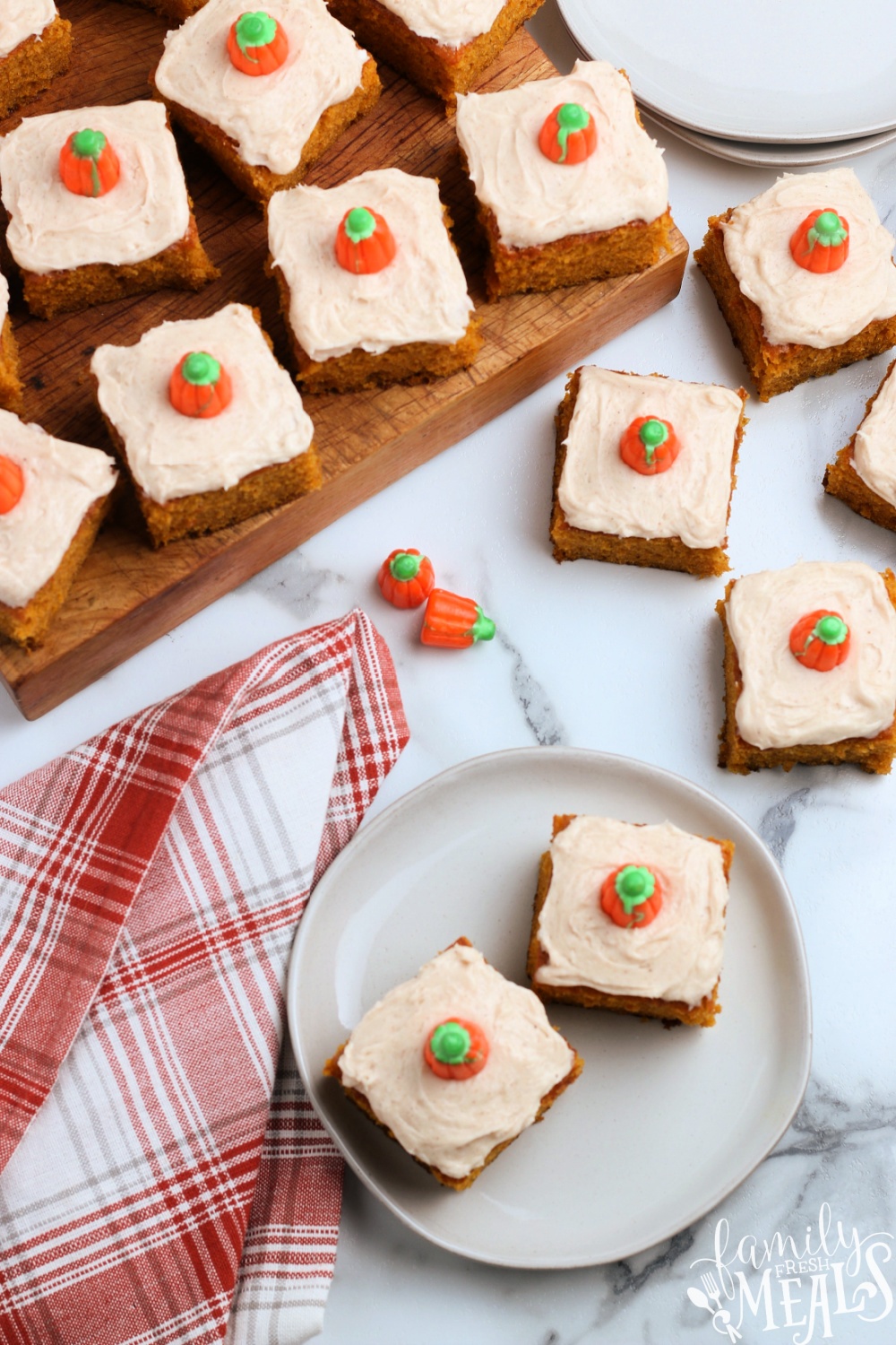 These super soft pumpkin bars are topped with a creamy pumpkin spice topping. Hands down these are the best pumpkin bars with cream cheese frosting! via @familyfresh