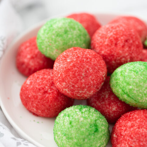 Red and Green Butter Cookies stacked on a plate