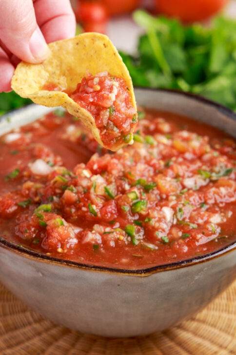 Chip dipping into Restaurant Style Salsa