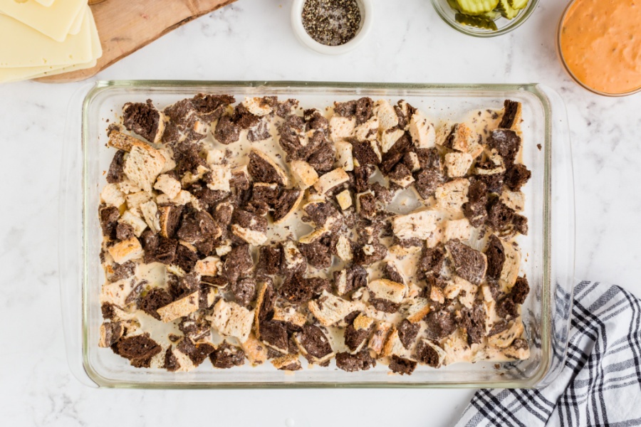 dressing mixed into bread cubes in the baking dish