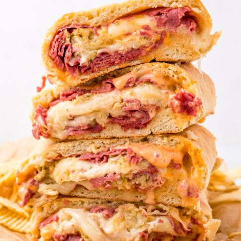 Reuben Garbage Bread pieces stacked on cutting board