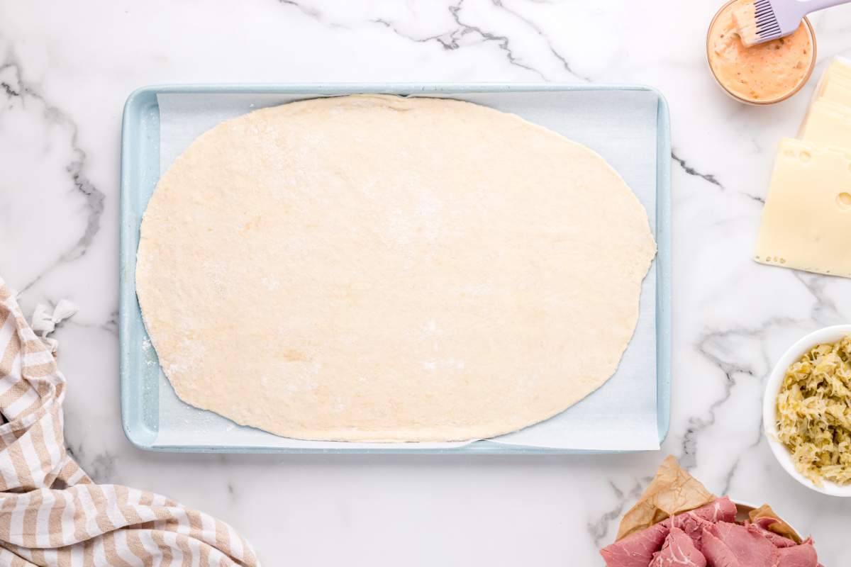 pizza dough on baking sheet