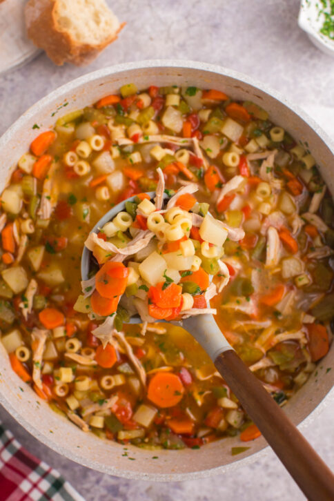 pot of soup with spoon scooping up some