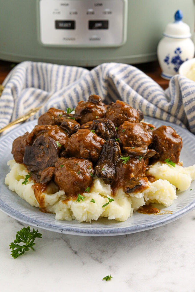 Slow Cooker Salisbury Meatballs on a plate with mashed potatoes