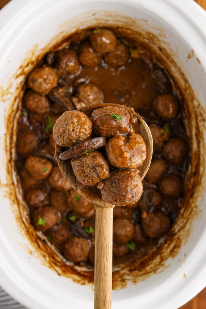 Slow Cooker Salisbury Meatballs being scooped up with a spoon