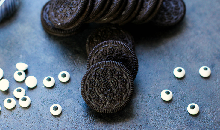 Spooky Halloween Oreos - Oreo cookies and candy eyeballs on a baking sheet