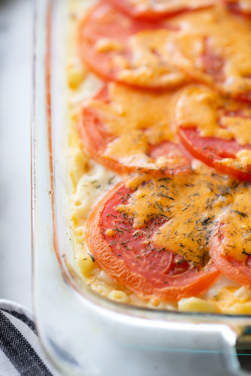 This Creamy Tuna Melt Casserole is layered with tomato slices, cheese, and a sprinkle of dried dill, and baked until golden. via @familyfresh