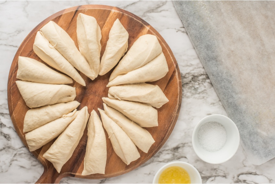 dough divided into 16 pieces on a cutting board