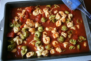 Top down shot of ravioli in a baking pan with sauce