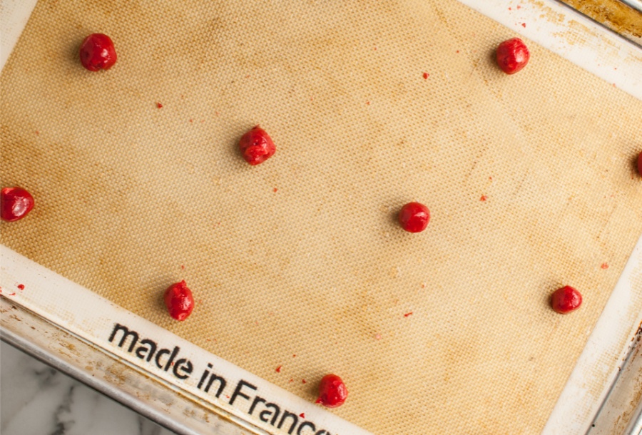 small cookie dough balls on cooking sheet